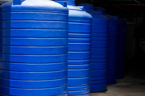Blue water tank of industrial building. Water storage tanks. Water tank on roof