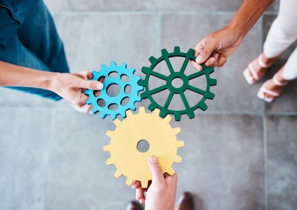 Settings, gear icon and teamwork with business people or team together for collaboration and synerg
