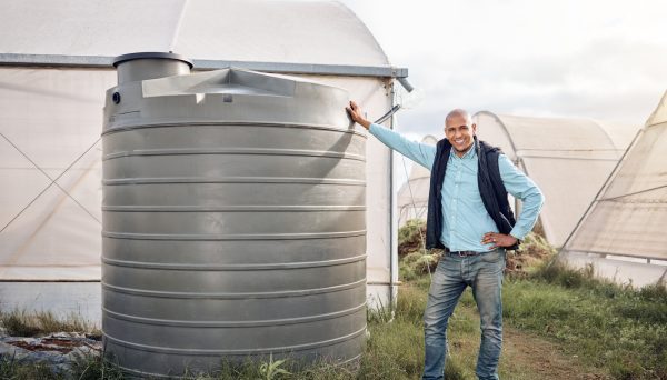 Man, portrait and water tank in farming liquid or soil hydration for vegetables, food and crops gro