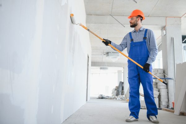 painter man painting the wall, with paint roller
