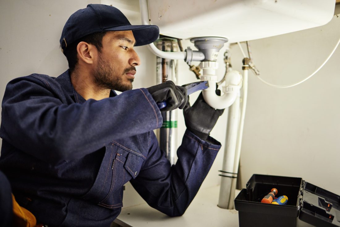 Plumbing, pipes and maintenance with man in kitchen for repair, industrial and inspection. Handyman Plumbing, pipes and maintenance with man in kitchen for repair, industrial and inspection. Handyman