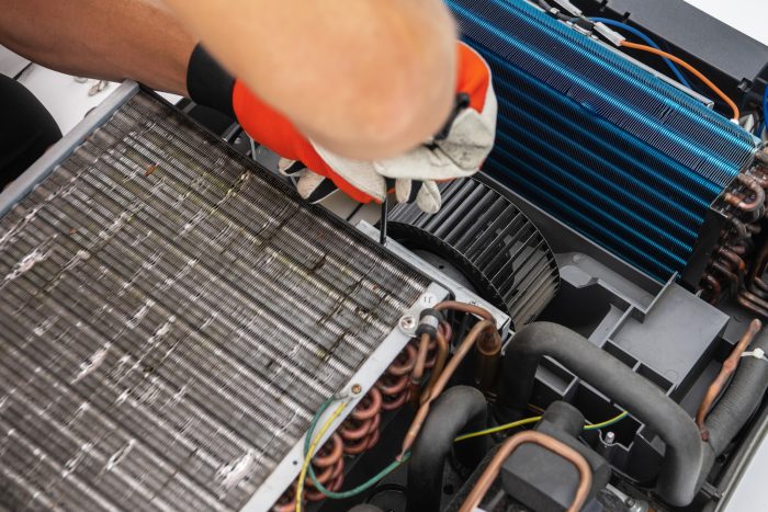Technician Working on RV Recreational Vehicle AC Unit With Screwdriver Technician Working on RV Recreational Vehicle AC Unit With Screwdriver